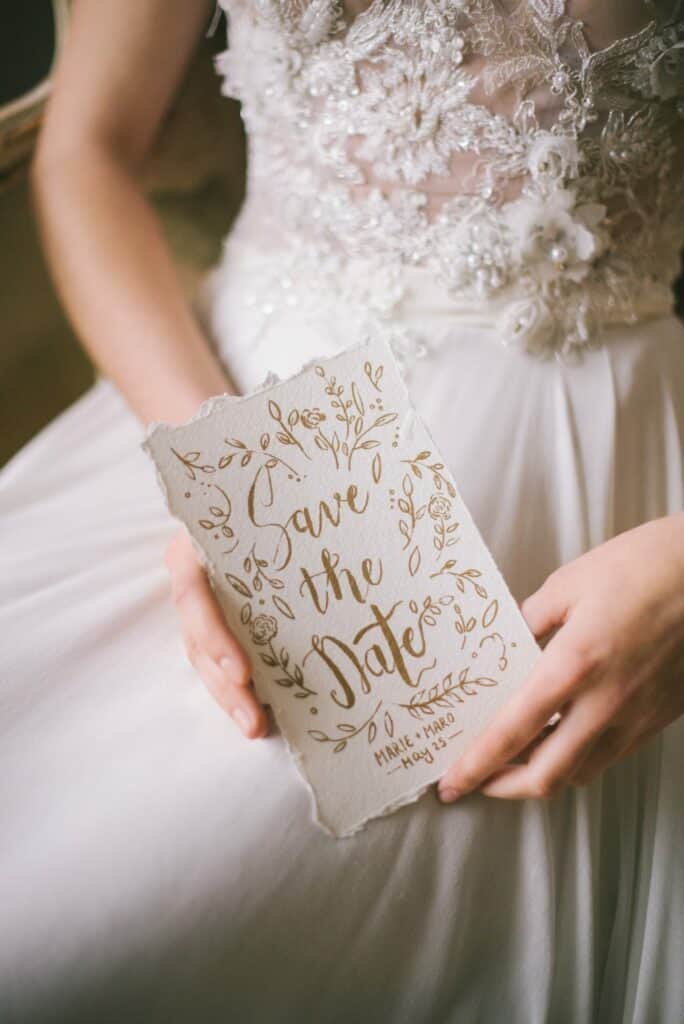 Bride holding a save the date card
